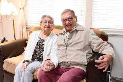 Two clients sit on a couch together