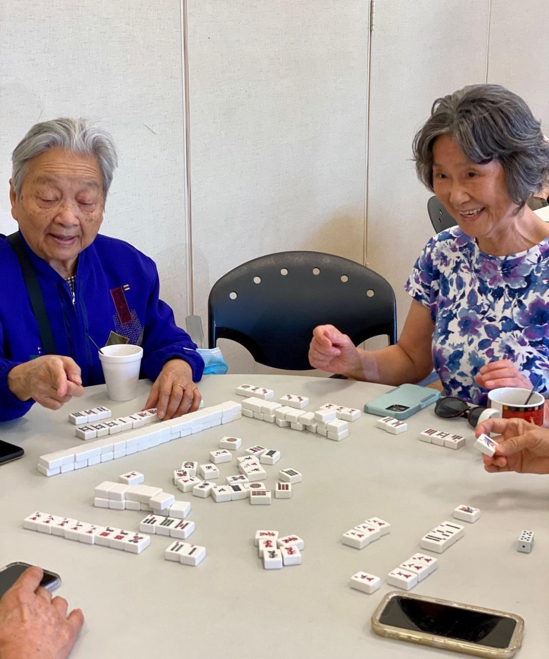 Clients at our Five Points Friendship Cafe learn and play mahjong before lunch is served.